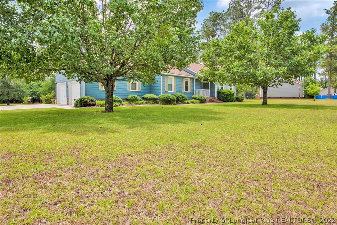 22 Woodridge Lane Cameron, NC 28326 - Photo 32 of 33 a front view of a house with a garden