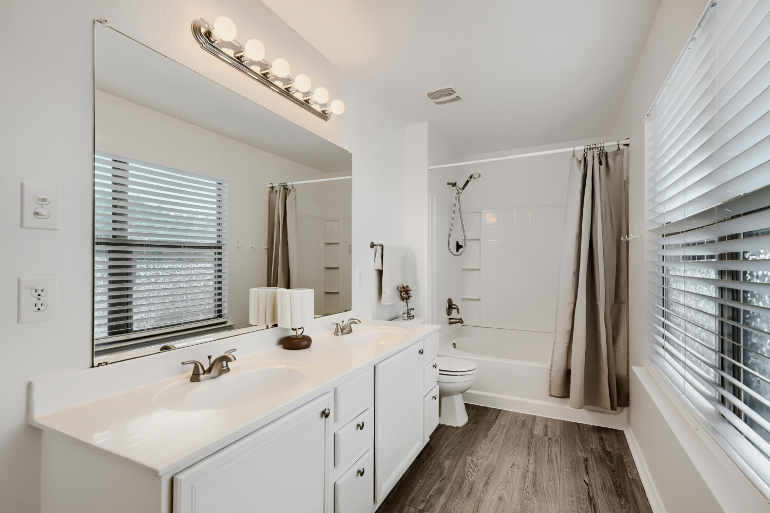 4508 Peach Grove Road Austin, TX 78744 - Photo 14 of 22 Clean lines flooring define this functional double vanity bathroom.