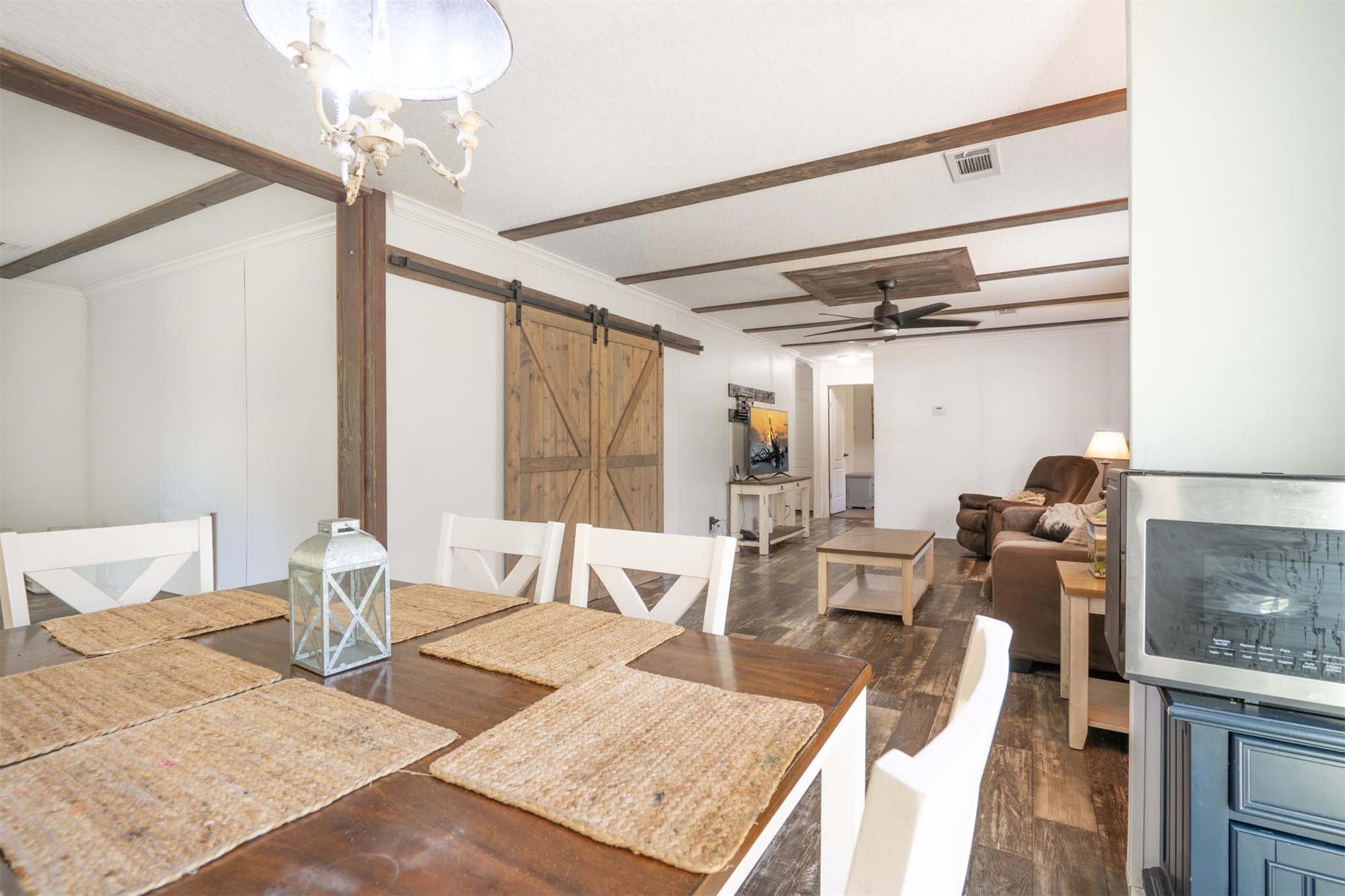 76220 Dove Road Yulee, FL 32097 - Photo 18 of 48 a view of a dining room with furniture a chandelier and wooden floor