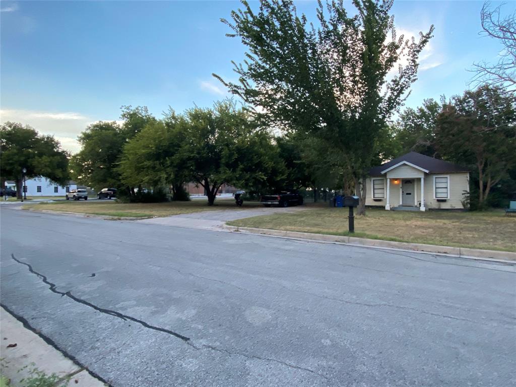 229 South Wilson Street Burleson, TX 76028 - Photo 6 of 16 a view of house with outdoor space and trees in the background