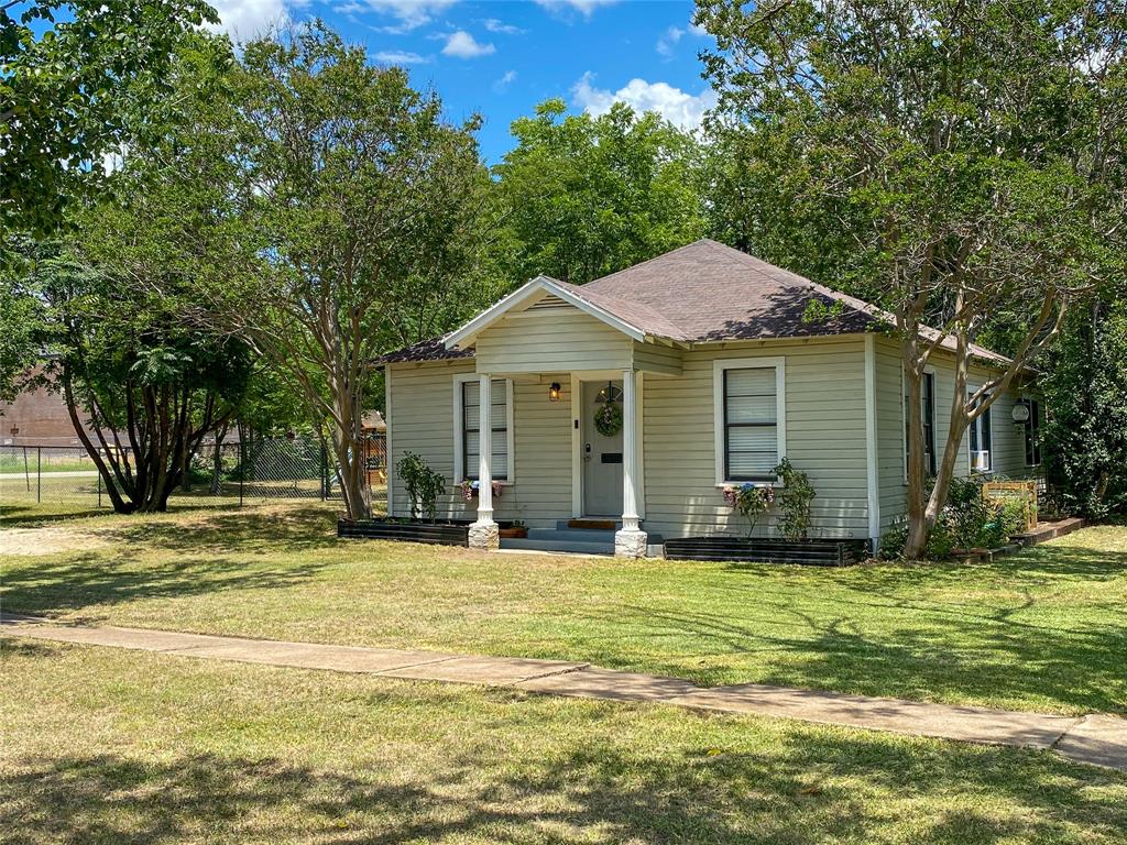 229 South Wilson Street Burleson, TX 76028 - Photo 8 of 16 a view of a house with a swimming pool