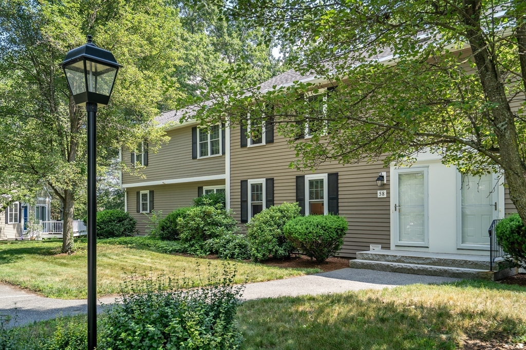 58 MacIntosh Lane, Unit 58 Boxborough, MA 01719 - Photo 1 of 23 a front view of a house with garden