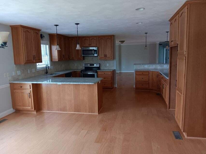 2763 Trinity Road Troutville, VA 24175 - Photo 5 of 21 a kitchen with stainless steel appliances a sink a stove a microwave a sink a refrigerator and cabinets