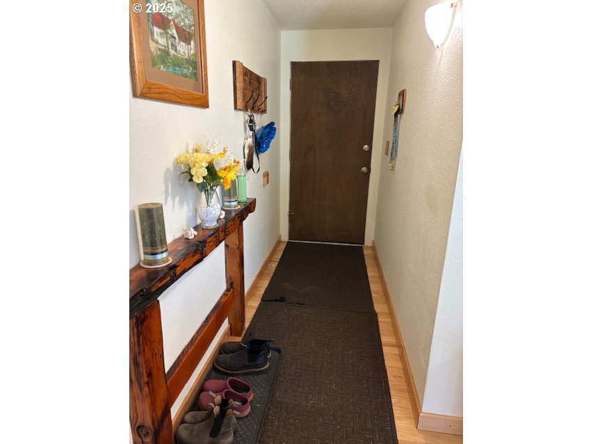 34851 Seavey Loop Road Eugene, OR 97405 - Photo 6 of 34 a view of a hallway with wooden floor