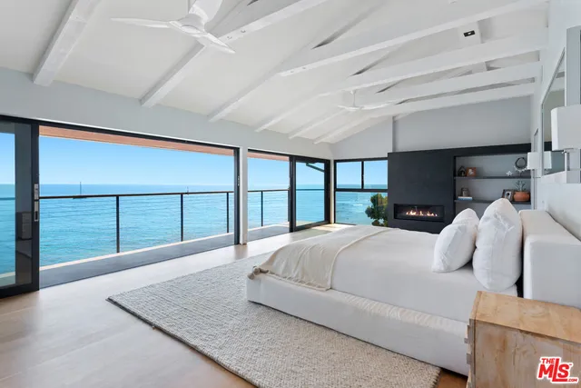 a bedroom with a large bed and a large window