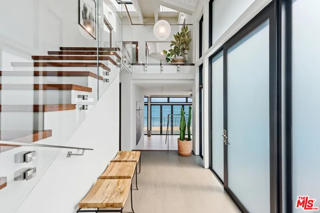 a view of entryway and hall with wooden floor