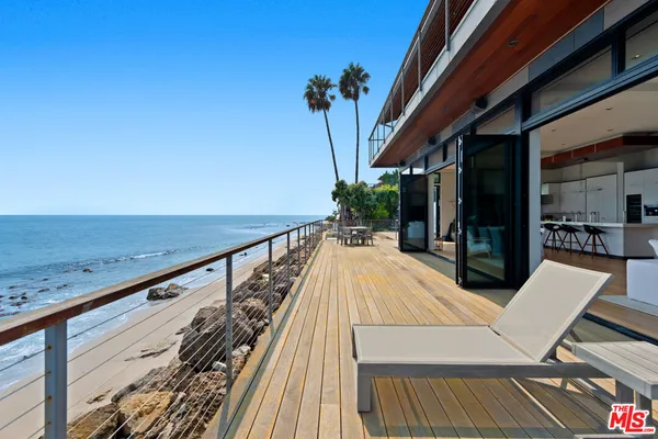 a view of balcony with wooden floor and outdoor seating