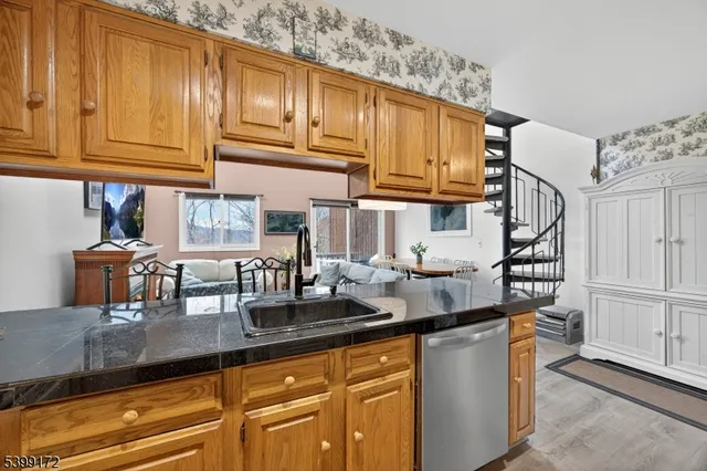 a kitchen with granite countertop a sink and cabinets