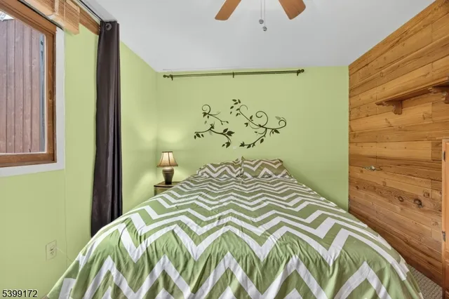 a bedroom with a bed and a window