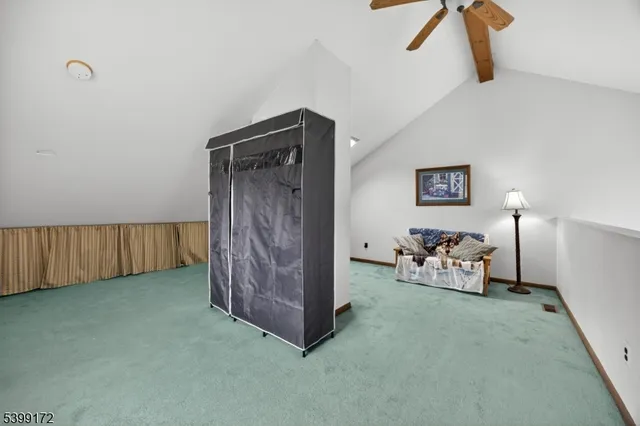 a view of a livingroom with furniture and a fan