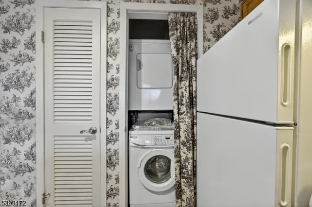 a kitchen with a refrigerator and a washer dryer