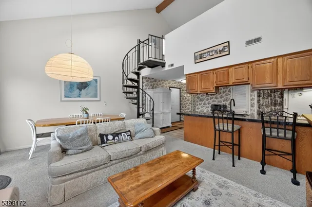 a living room with furniture a rug and a chandelier