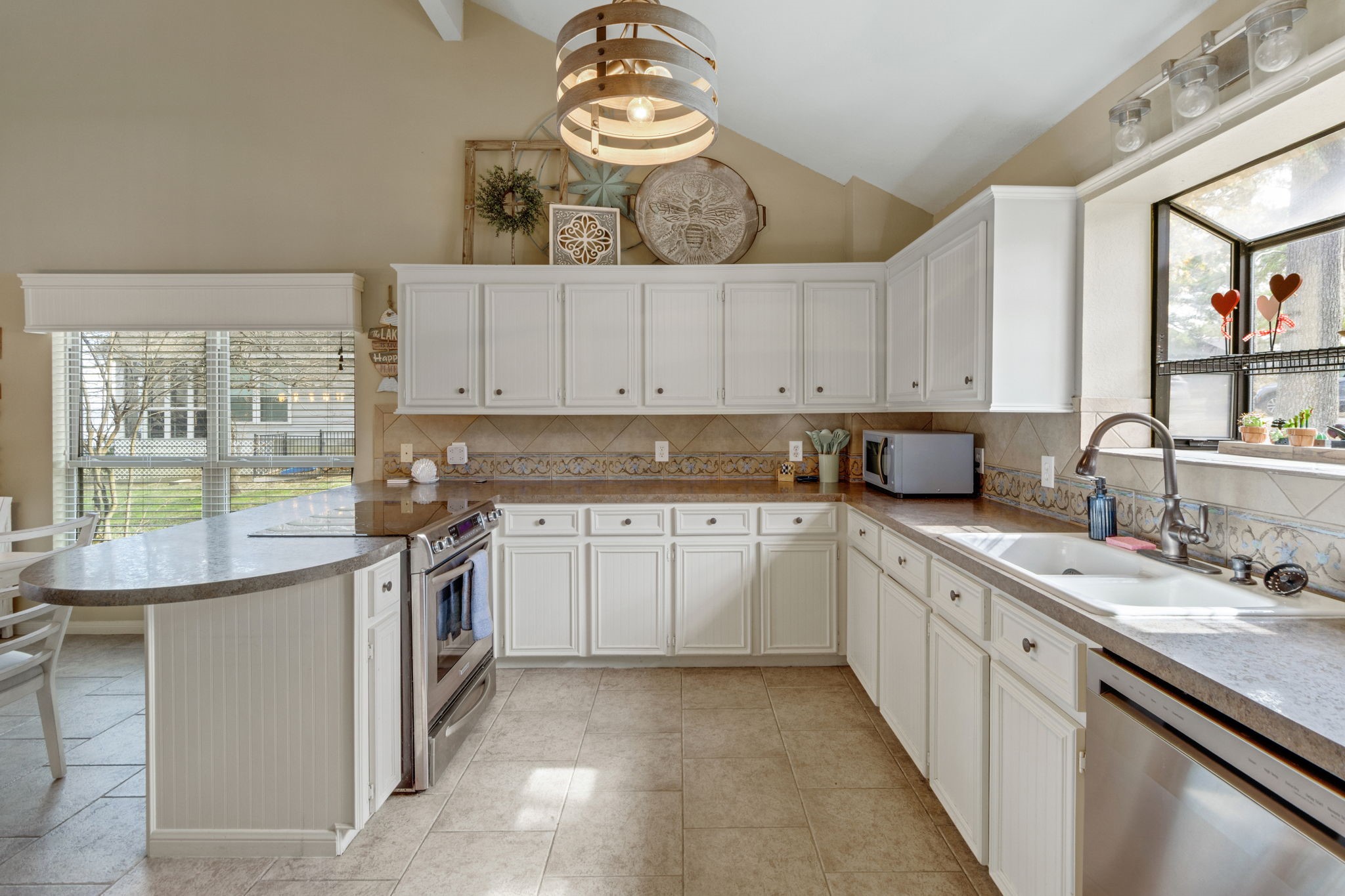 81 Harbour Point Circle Coldspring, TX 77331 - Photo 12 of 44 The kitchen features white cabinetry and stainless steel appliances