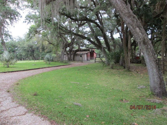 5320 Buckingham Road Fort Myers, FL 33905 - Photo 23 of 25 a view of a house with a big yard and large trees