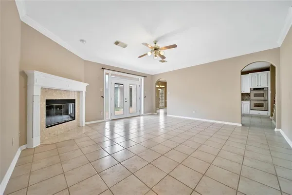 a view of an empty room with a fireplace and a window