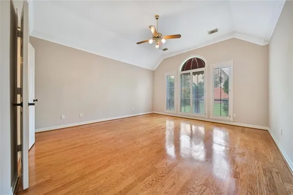 a view of empty room with wooden floor