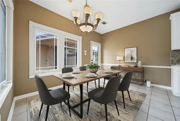 a view of a dining room with furniture and a chandelier