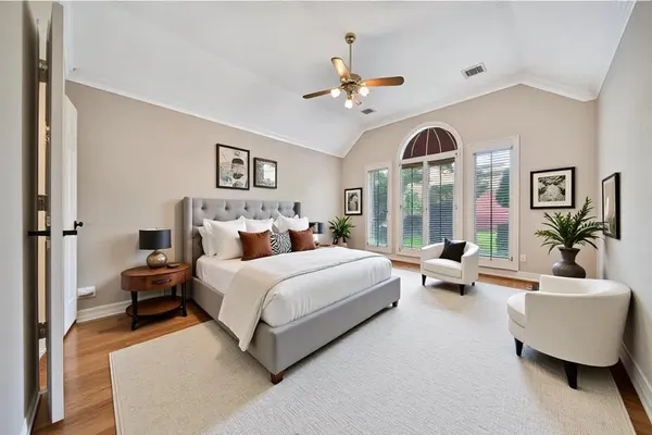 a bedroom with a large bed and a chandelier