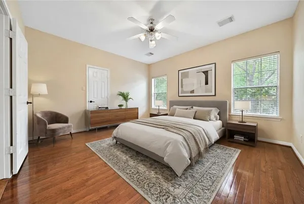 a spacious bedroom with two beds and a chandelier