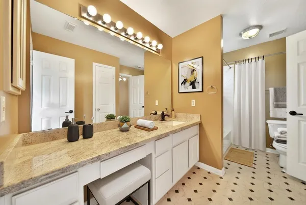 a bathroom with a sink double vanity and a mirror