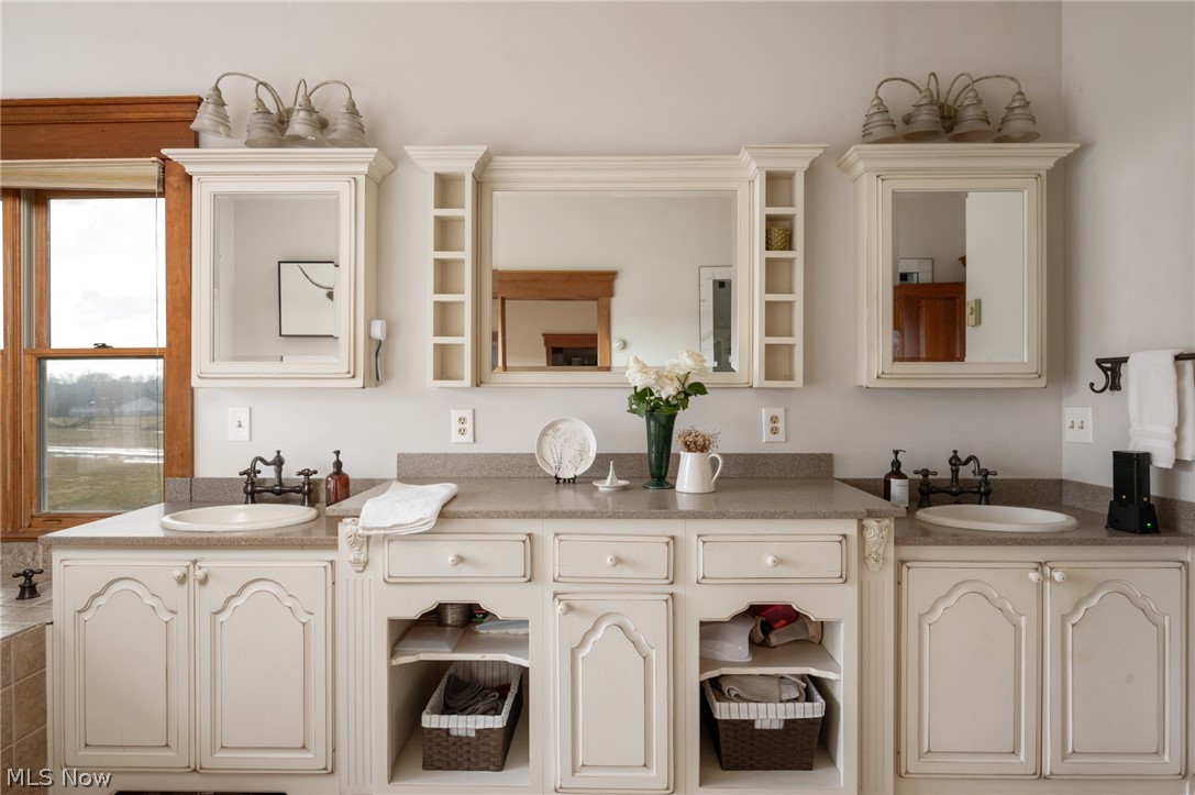 9419 Robinson Road Chardon, OH 44024 - Photo 23 of 46 Bathroom featuring double vanity and two vanities