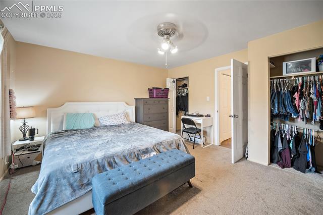 1921 Wooten Road Colorado Springs, CO 80915 - Photo 18 of 49 Carpeted bedroom with a closet and ceiling fan