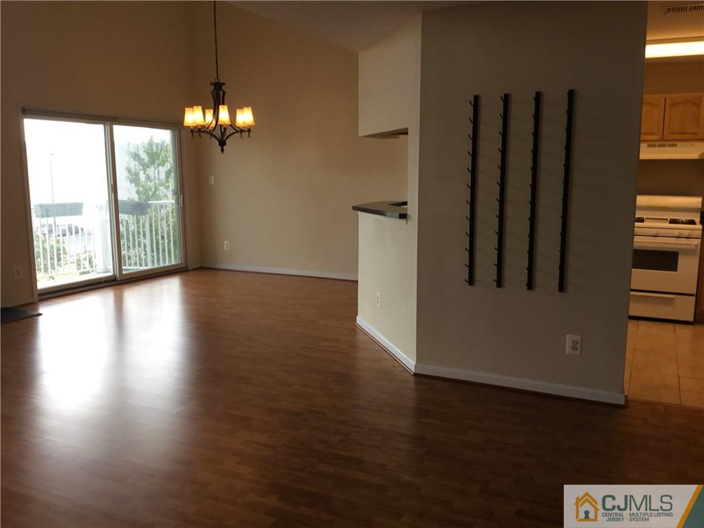 1132 Edpas Road, Unit 1132 New Brunswick, NJ 08901 - Photo 4 of 19 a view of a livingroom with wooden floor and chandelier