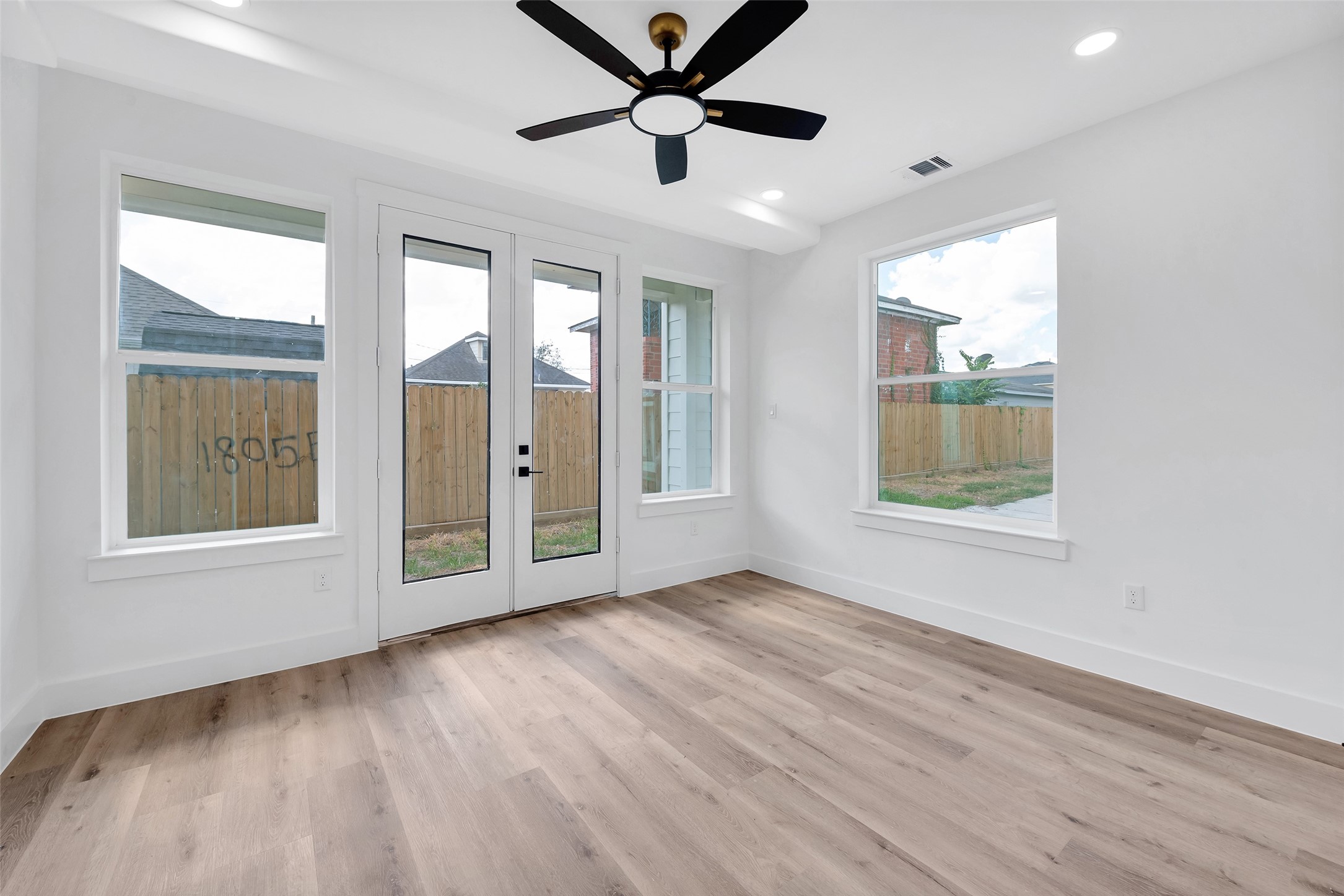 1805 Emir Street, Unit G Houston, TX 77009 - Photo 12 of 43 a view of an empty room with a window and wooden floor