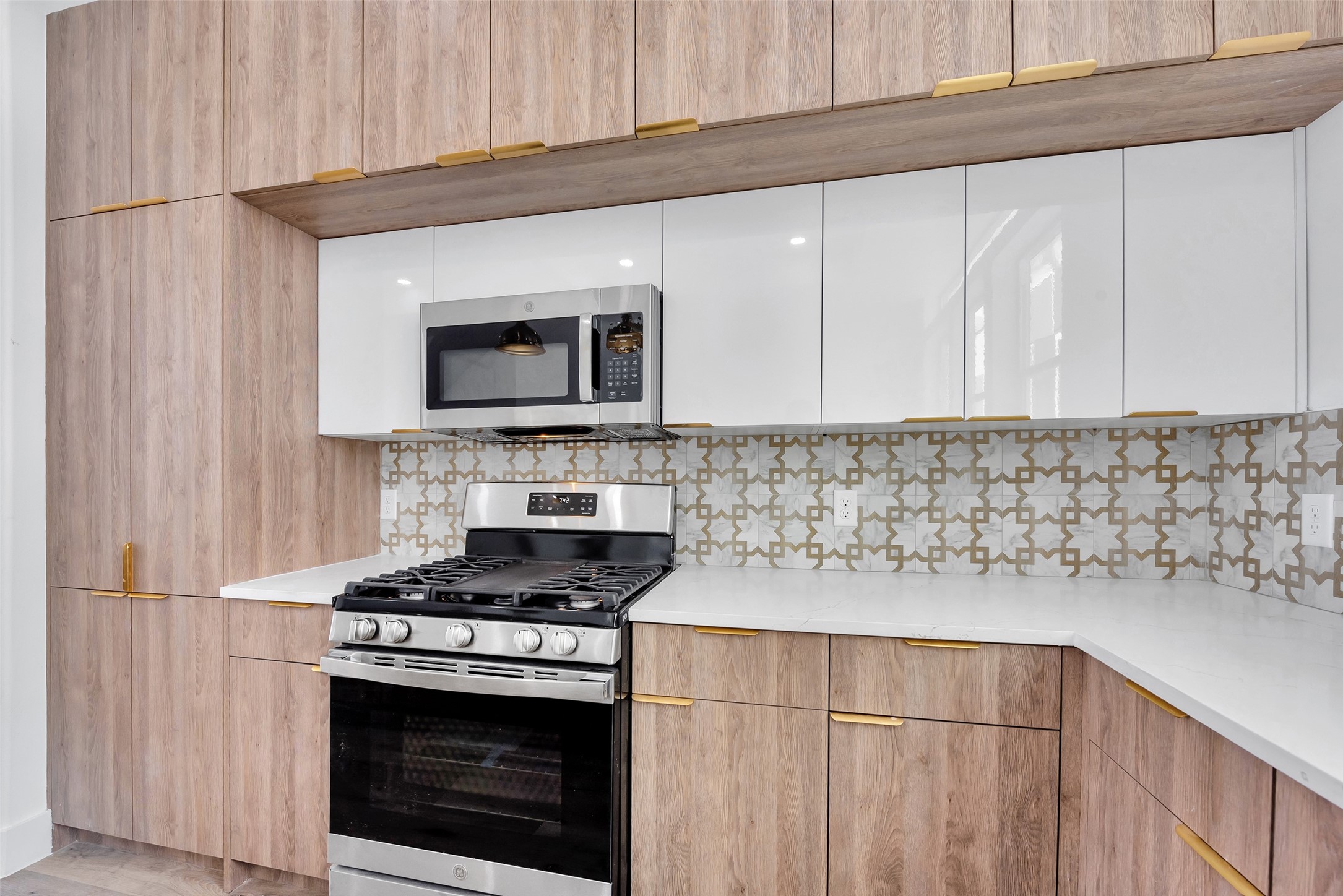 1805 Emir Street, Unit G Houston, TX 77009 - Photo 20 of 43 a kitchen with stainless steel appliances white cabinets and a stove top oven