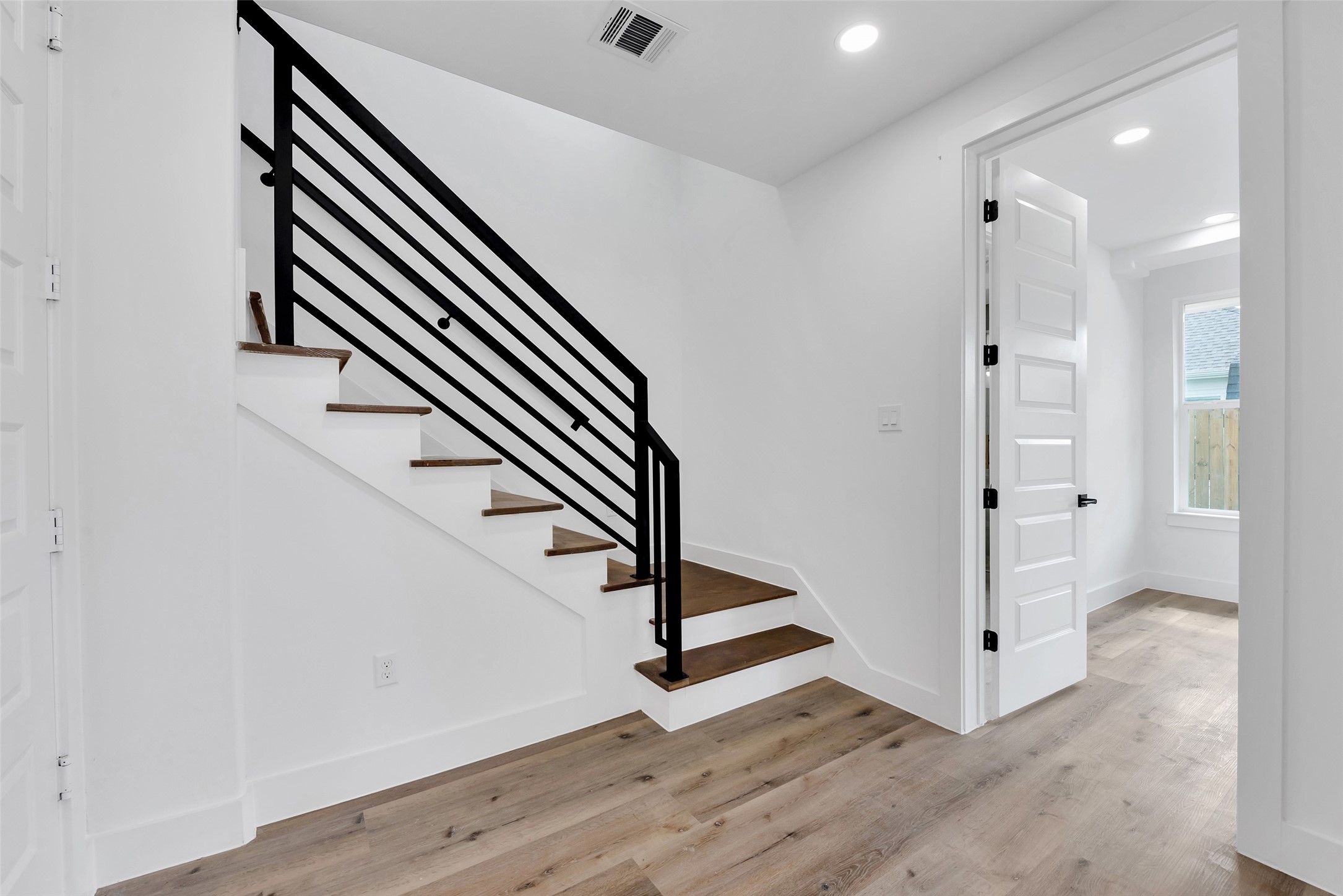 1805 Emir Street, Unit G Houston, TX 77009 - Photo 7 of 43 an entryway in a hall with a window and wooden floor