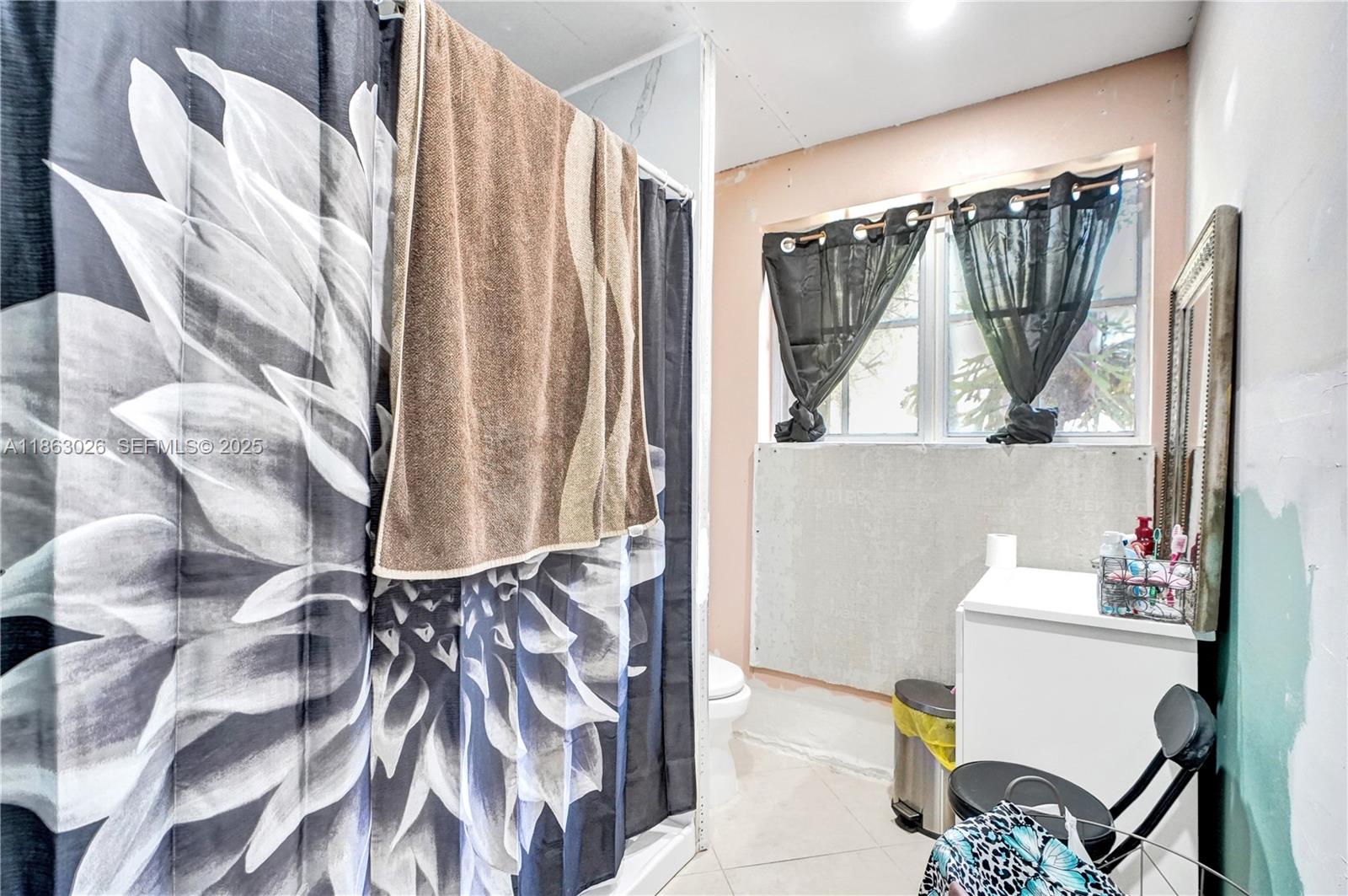 14824 Southwest 180th Street Miami, FL 33187 - Photo 13 of 49 a bathroom with a bathtub a mirror and a shower curtain