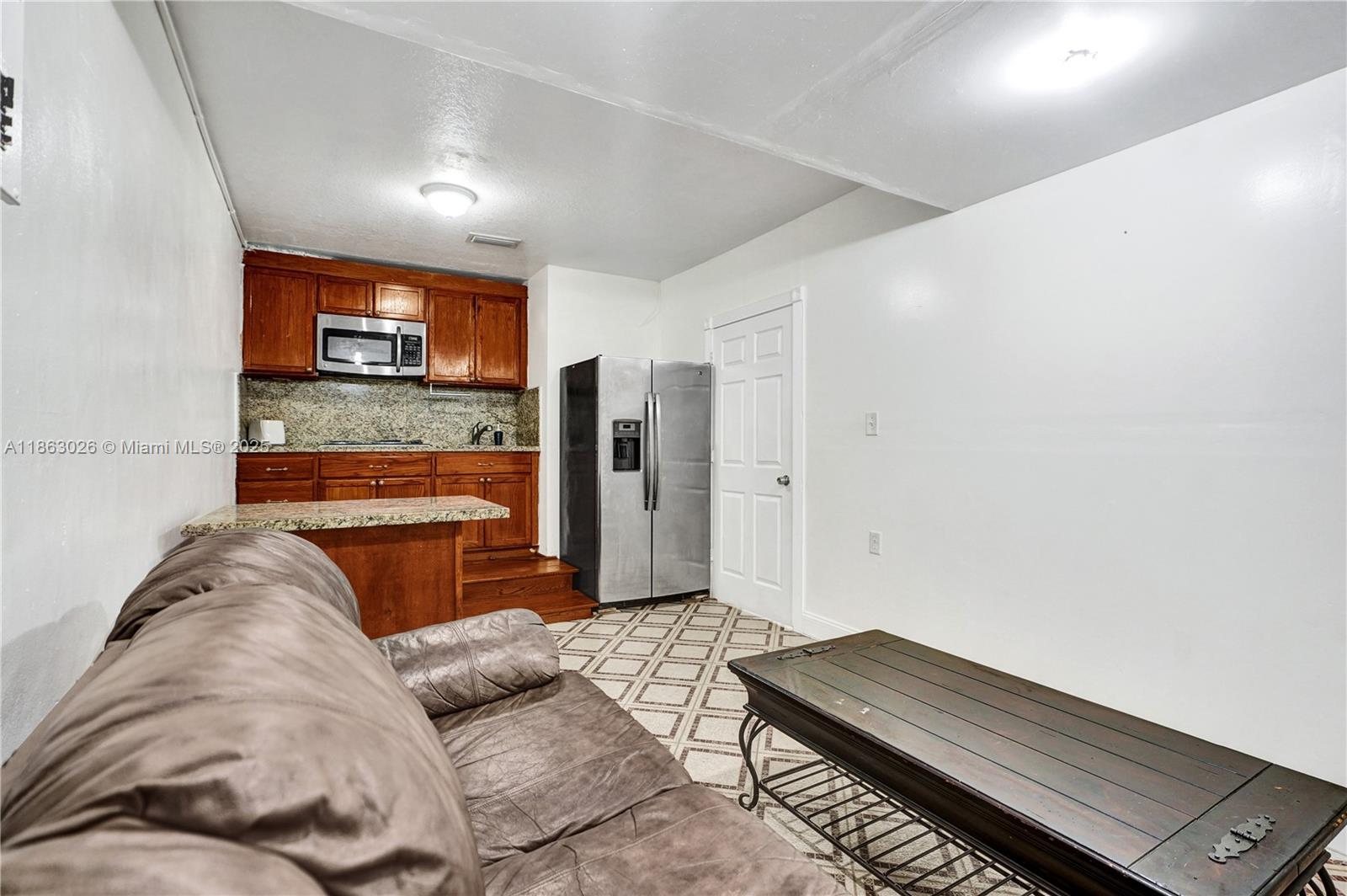 14824 Southwest 180th Street Miami, FL 33187 - Photo 22 of 49 a living room with furniture and a flat screen tv