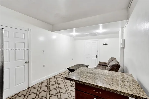a bathroom with a granite countertop sink and vanity