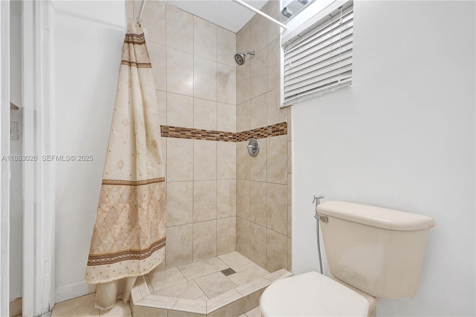 14824 Southwest 180th Street Miami, FL 33187 - Photo 25 of 49 a bathroom with a toilet and a shower
