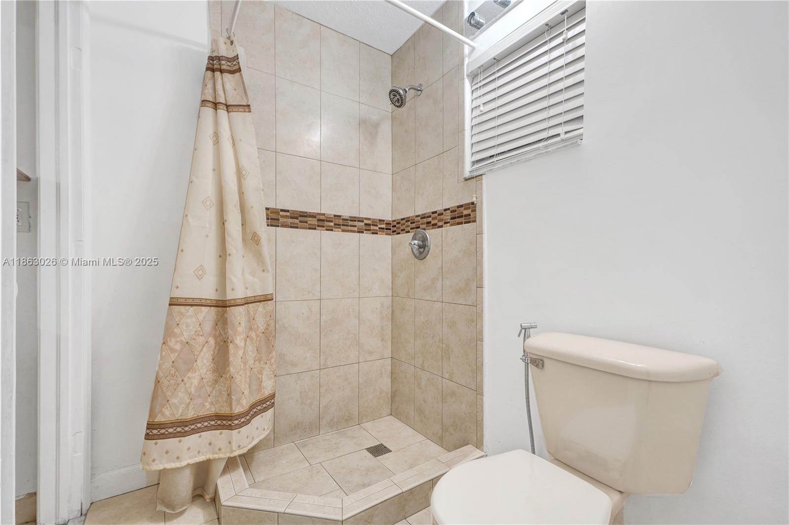 14824 Southwest 180th Street Miami, FL 33187 - Photo 25 of 49 a bathroom with a toilet and a shower