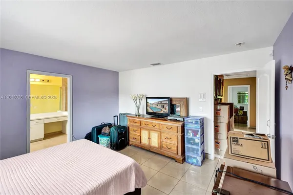 a bedroom with a bed and a television