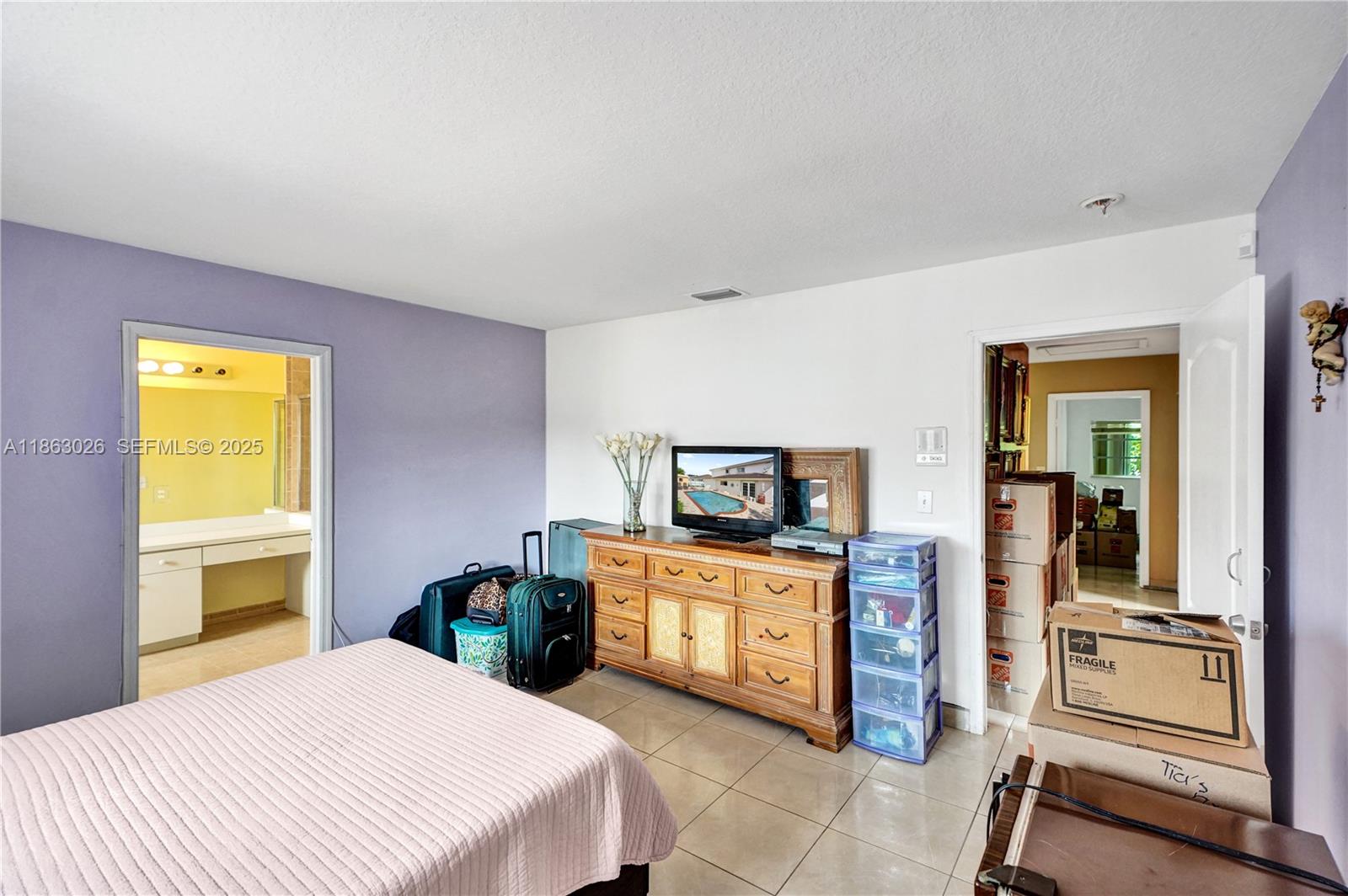 14824 Southwest 180th Street Miami, FL 33187 - Photo 41 of 49 a bedroom with a bed and a television