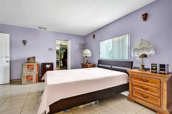 a bedroom with a bed and dresser