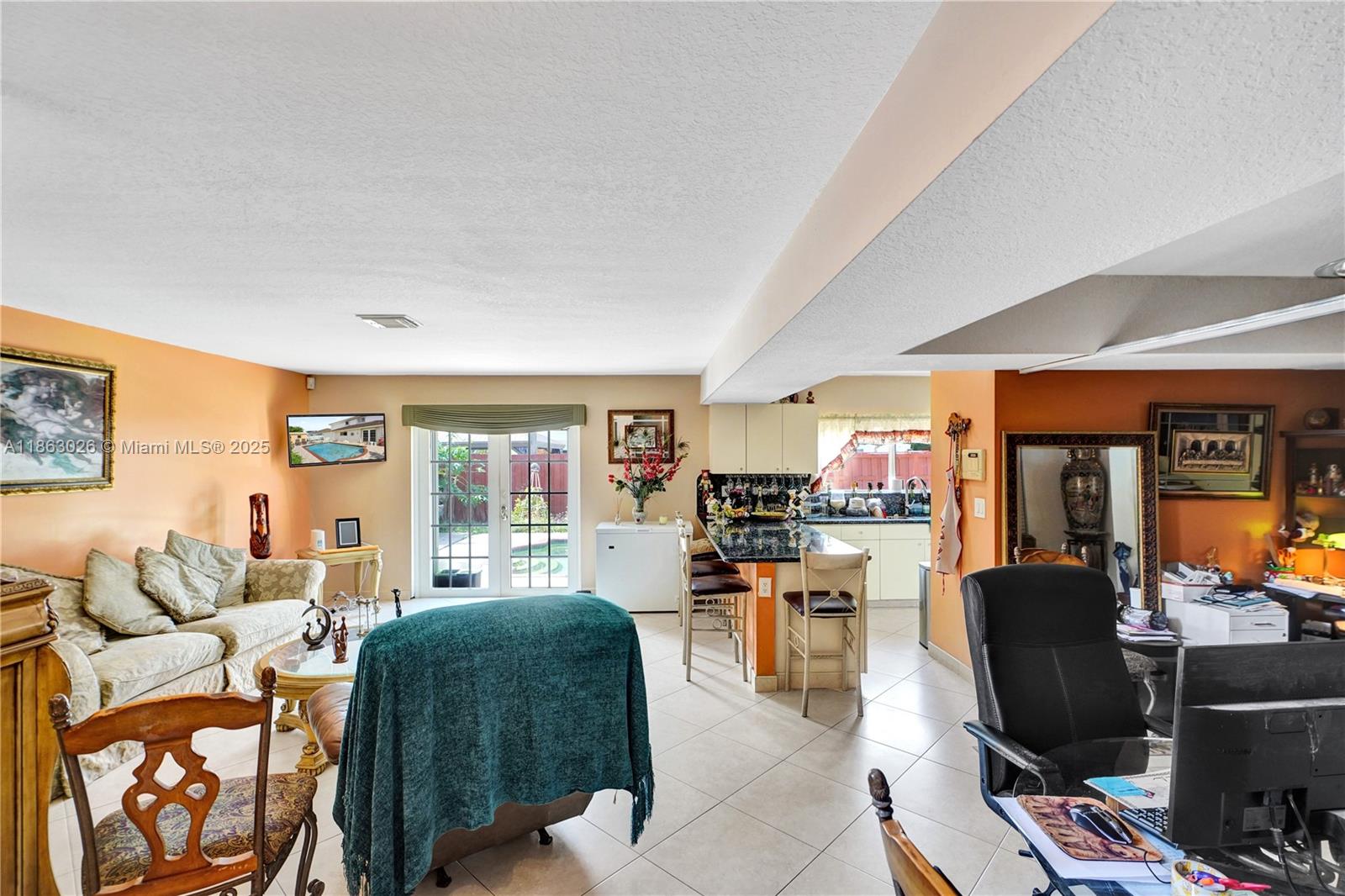 14824 Southwest 180th Street Miami, FL 33187 - Photo 5 of 49 a living room with furniture and a flat screen tv