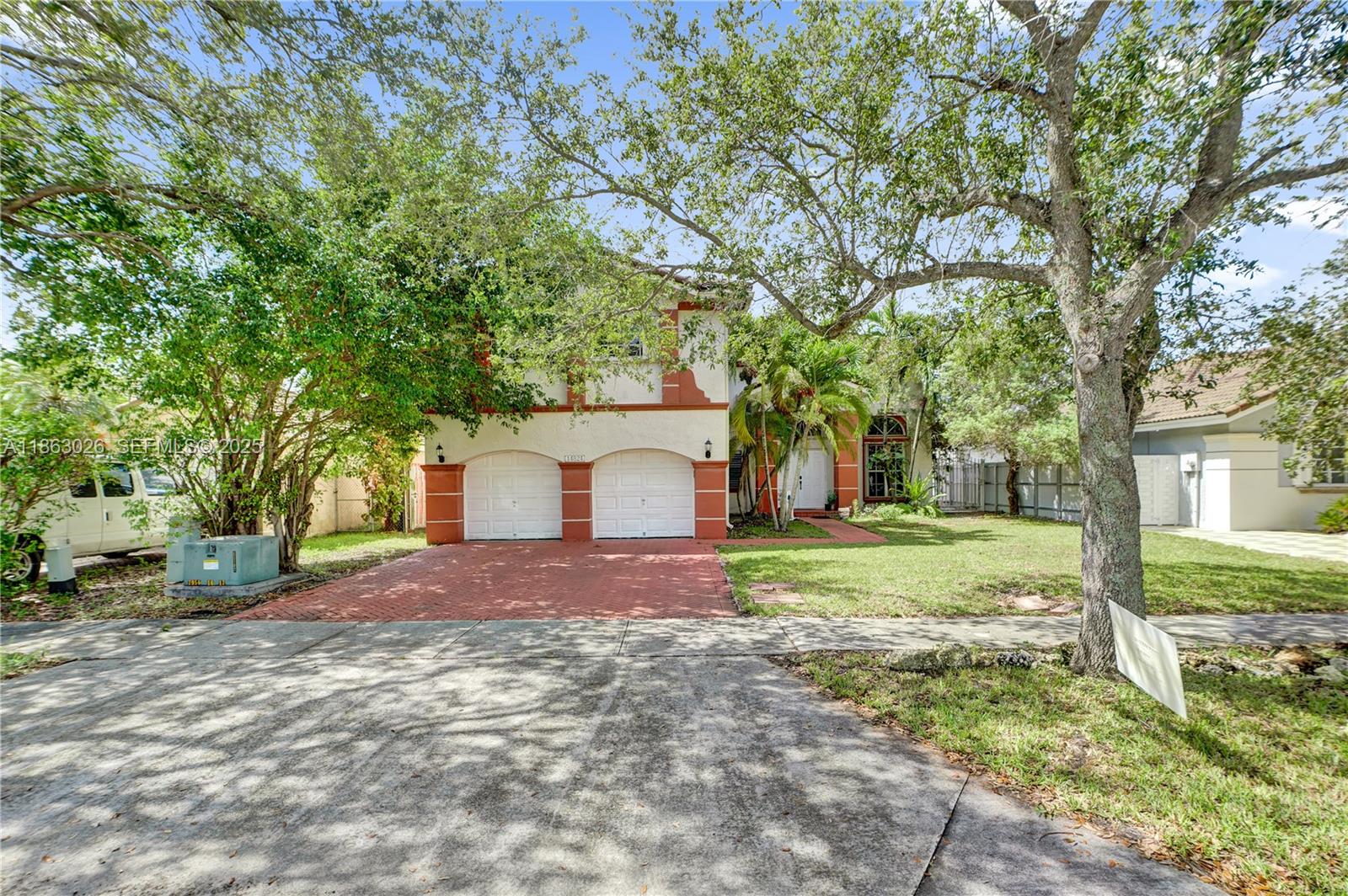 14824 Southwest 180th Street Miami, FL 33187 - Photo 6 of 49 a house with trees in front of it