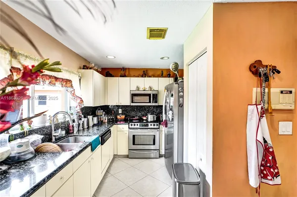 a kitchen with stainless steel appliances granite countertop a sink and cabinets