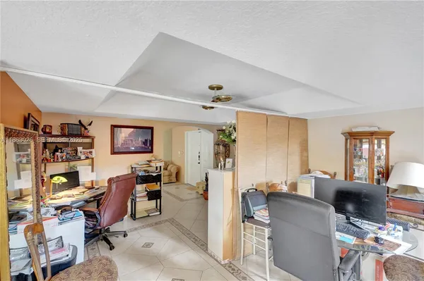 a view of a livingroom with workspace and a couch