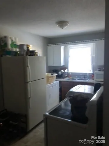 a kitchen with a refrigerator a sink and a stove