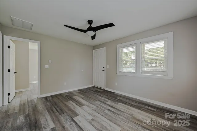 a view of room with hardwood floor and window