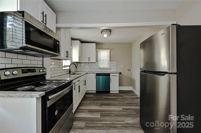 a kitchen with a refrigerator stove and microwave