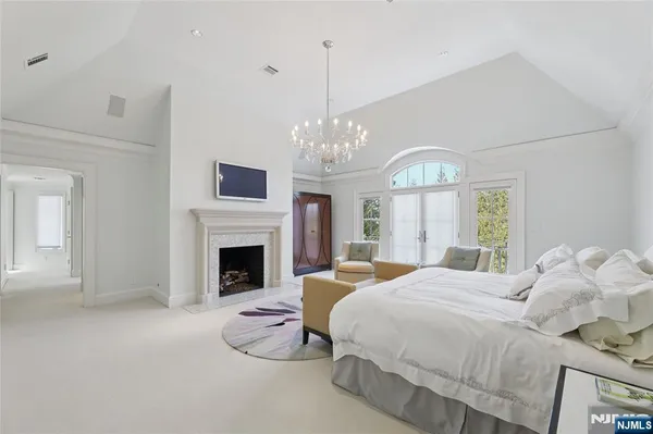 a large white kitchen with stainless steel appliances a sink and cabinets