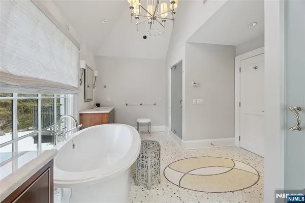 a bathroom with a shower sink vanity mirror and toilet