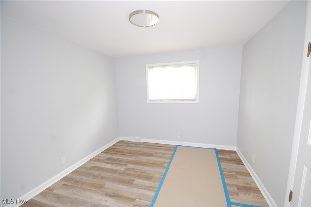 6284 Herbert Road Canfield, OH 44406 - Photo 18 of 24 Unfurnished room with light wood finished floors and baseboards