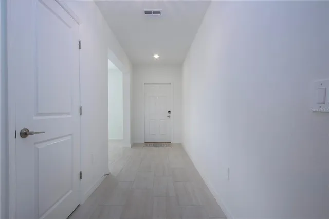 a view of an empty room and closet area