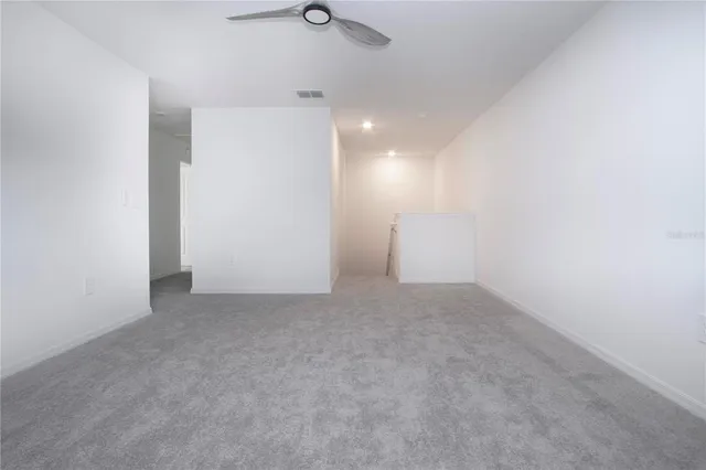 a view of a house with a small yard and palm trees